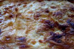 Вкусна баница с готови кори, яйца и сирене