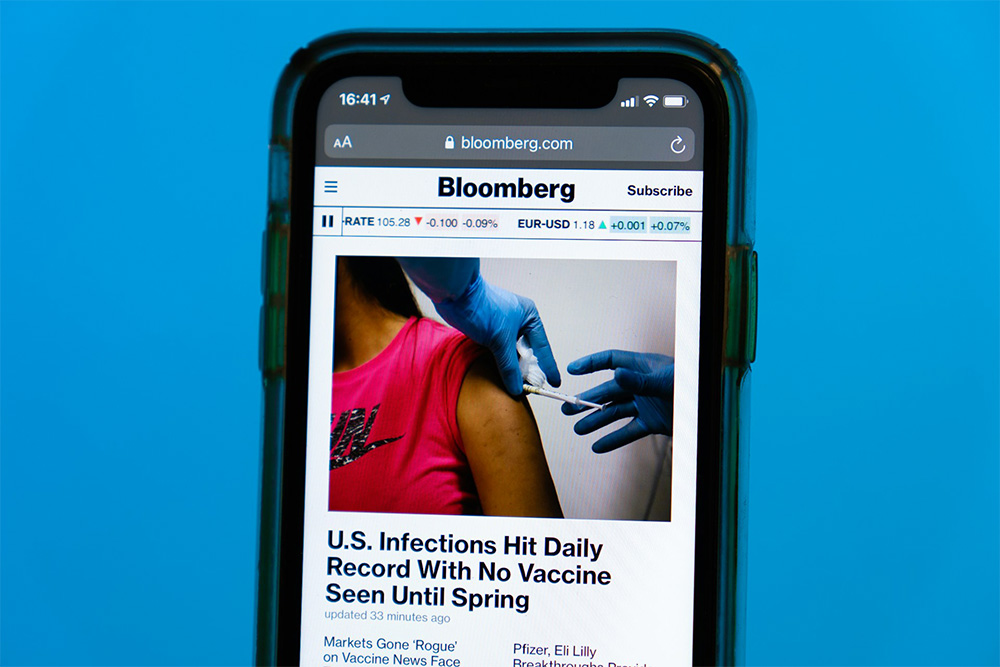 phone screen with a Bloomberg article